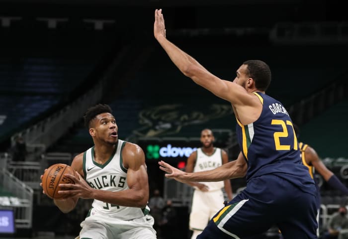 Rudy Gobert (27) defends Giannis Antetokounmpo (34) 